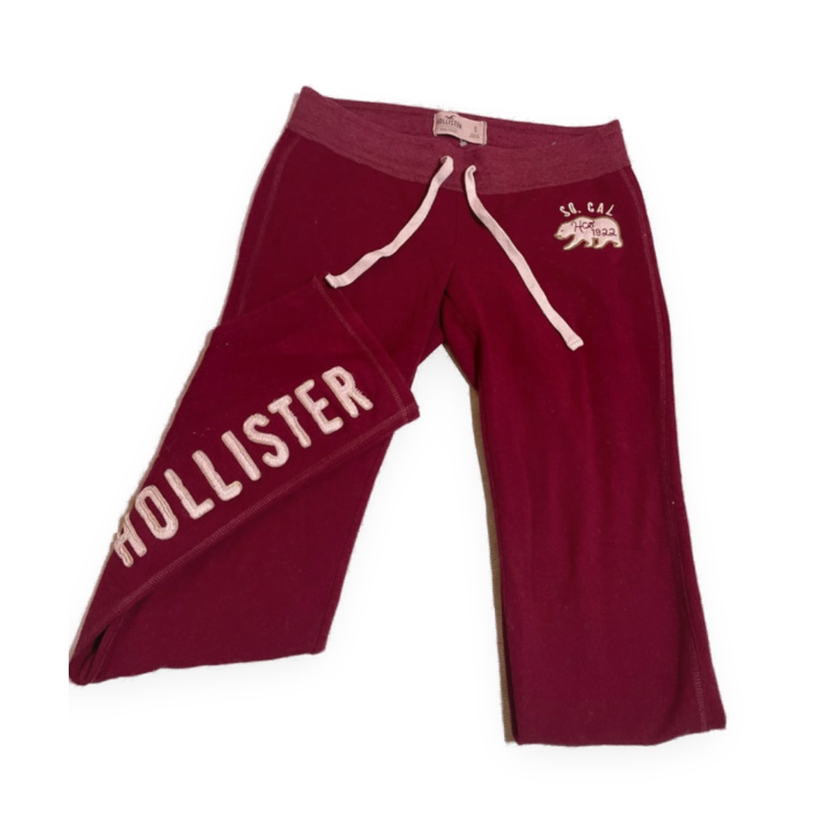 Vintage Hollister So. Cal burgundy joggers in size small, with pink chenille lettering down the leg, photographed on a clean white background.
